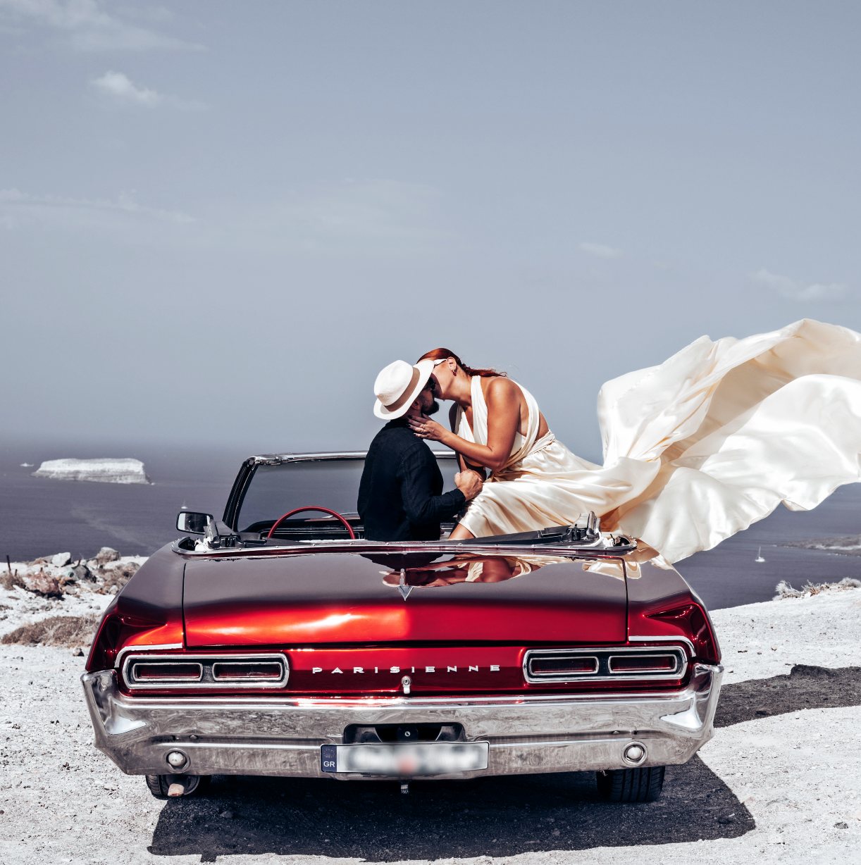 She said yes - Santorini proposal photography on the vintage Pontiac Parisienne overlooking the Aegean